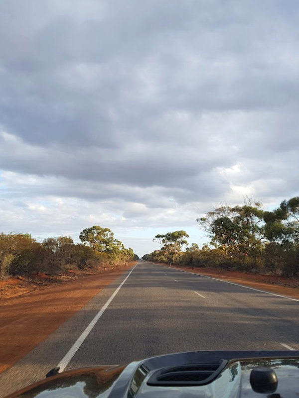 Jeep on Australian outback country road with red dirt near Exmouth 